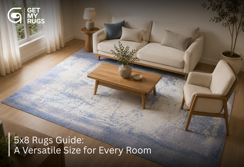 Abstract blue and ivory 5x8 area rug anchoring a small loveseat and accent chair in a bright living room