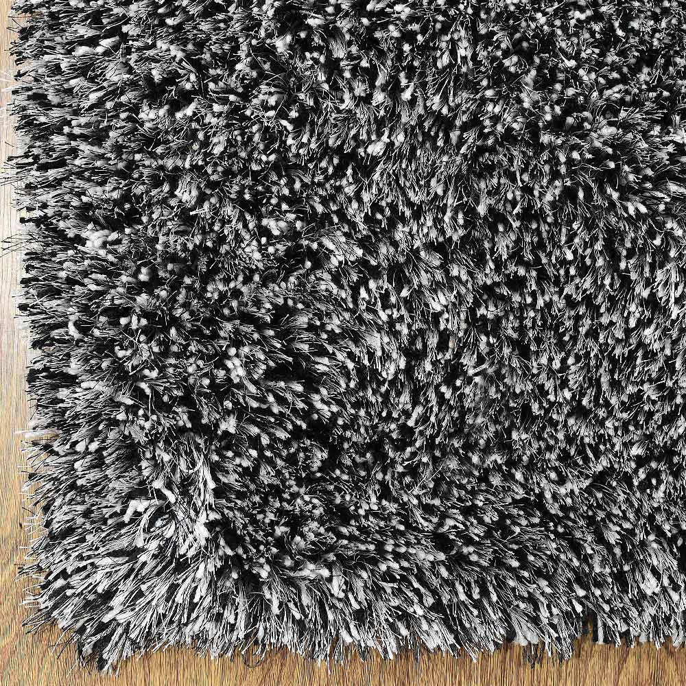 hand-tufted-shag-polyester-area-rug-solid-black-white-closeup 1