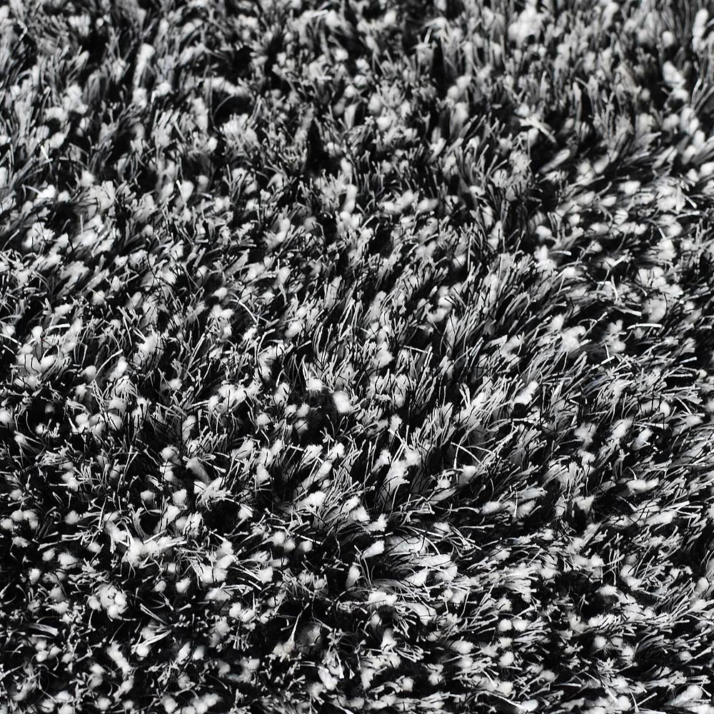 hand-tufted-shag-polyester-area-rug-solid-black-white-closeup 2