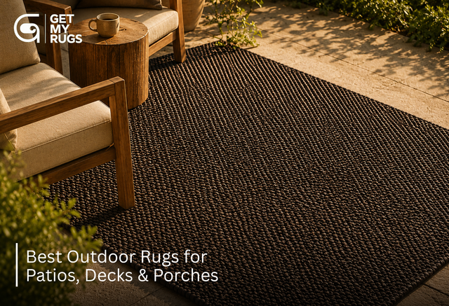 Braided jute outdoor rug in charcoal-taupe styled on a sunlit patio deck, showing natural fiber texture
