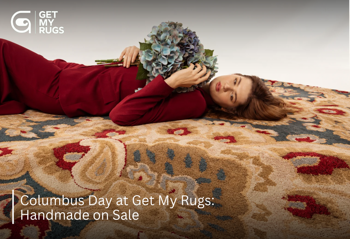Model reclining on a traditional camel and burgundy medallion rug holding blue hydrangeas, for Columbus Day sale