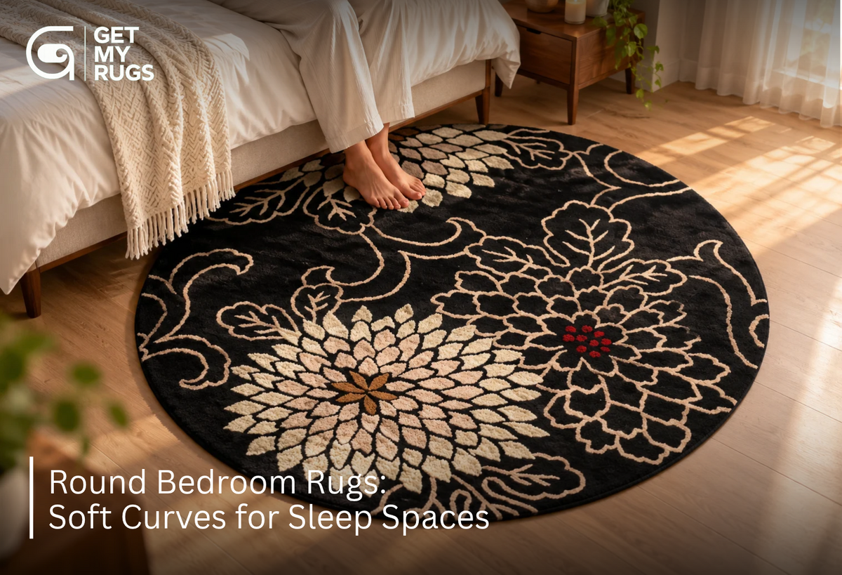 Black round bedroom rug with ivory chrysanthemum floral pattern centered beneath a bed, softening the room's straight lines