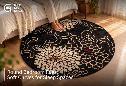 Black round bedroom rug with ivory chrysanthemum floral pattern centered beneath a bed, softening the room's straight lines