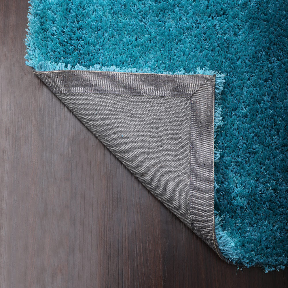 hand-tufted-shag-polyester-solid-turquoise-rectangle-rug-closeup-5