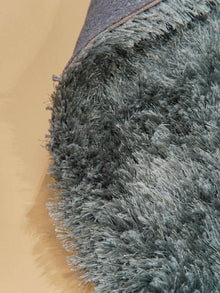 hand-tufted-shag-polyester-solid-dark-green-rectangle-rug-closeup-1