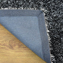 hand-tufted-shag-polyester-area-rug-solid-black-white-closeup 6
