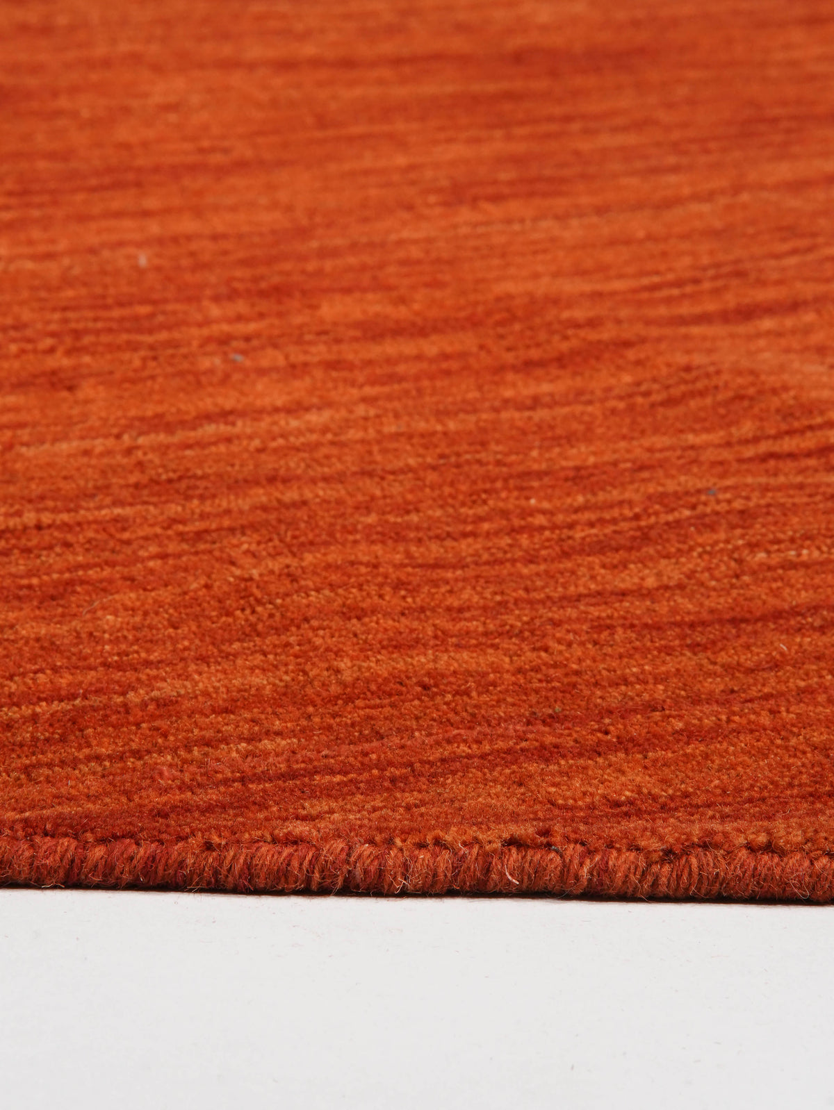 hand-knotted-loom-wool-solid-light-red-round-rug-closeup-3