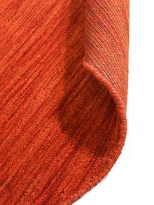 hand-knotted-loom-wool-solid-light-red-round-rug-closeup-5